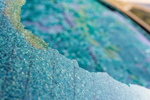 Rear car window cracked into tiny shards still in frame photo