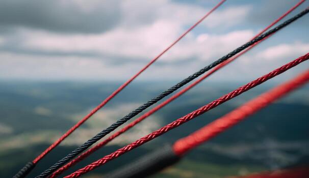 Close-up of paragliding lines against a cloudy sky photo