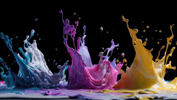 Colorful paint splashes on a black background photo