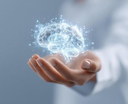 A hand holds a glowing, digital brain image photo