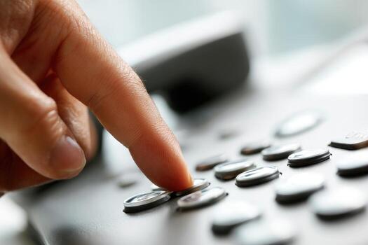 Close-up of a hand pressing a button on a phone photo