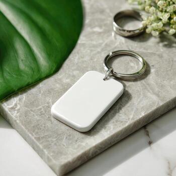 Blank rectangular keychain on marble with tropical leaf photo