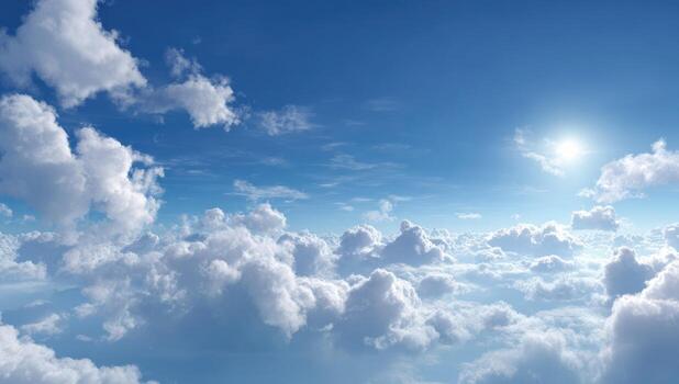 High-angle view of a vast, bright blue sky filled with fluffy white cumulus clouds, with a sun shining brightly photo