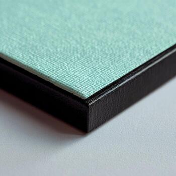 Close-up of a mint green canvas print with a black frame photo