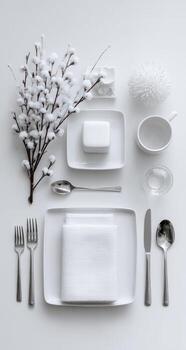 Flatlay of white tableware and decor photo