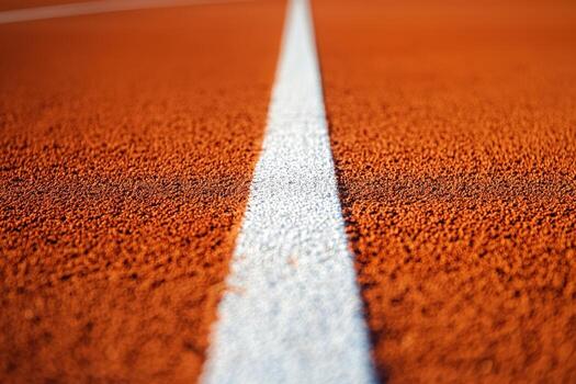 Close-up of a running track lane with a white line on orange surface photo