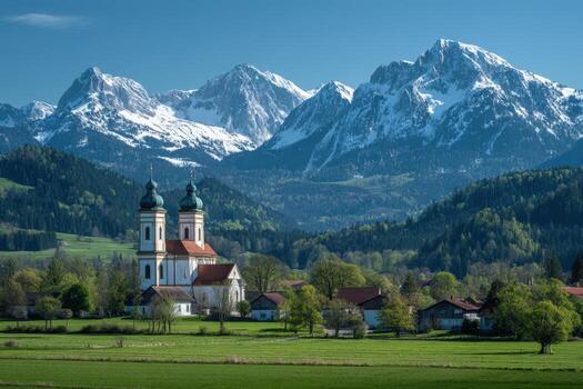 A church in the mountains with snow capped mountains in the background photo