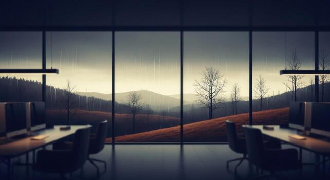 A room with two computers and a window looking out to the mountains photo