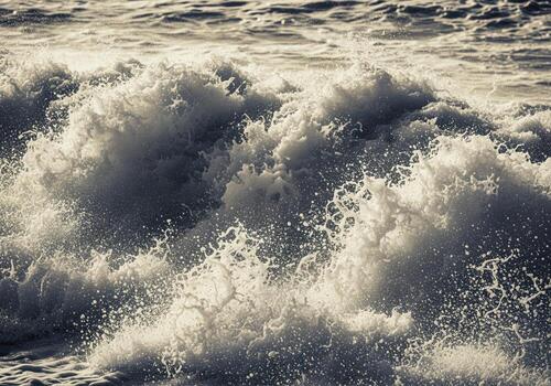 Powerful ocean wave breaking with white foam and spray during a severe storm photo
