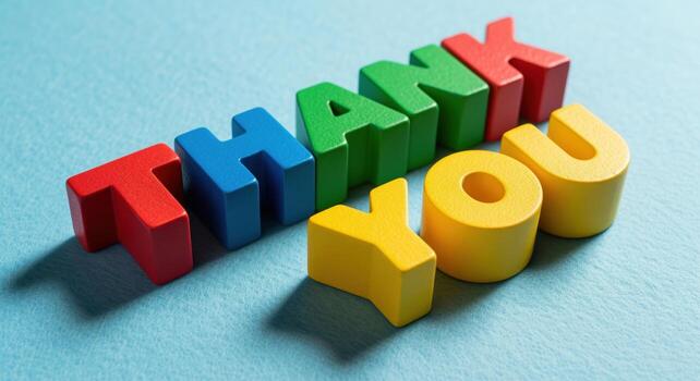 Brightly colored wooden blocks spelling THANK YOU arranged in a playful diagonal pattern photo