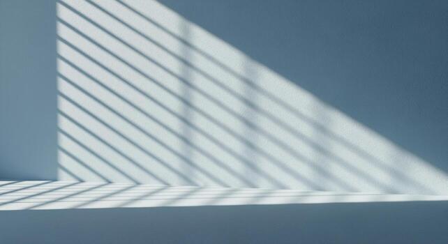 Modern minimalist pale blue backdrop with dramatic diagonal light and shadow patterns photo