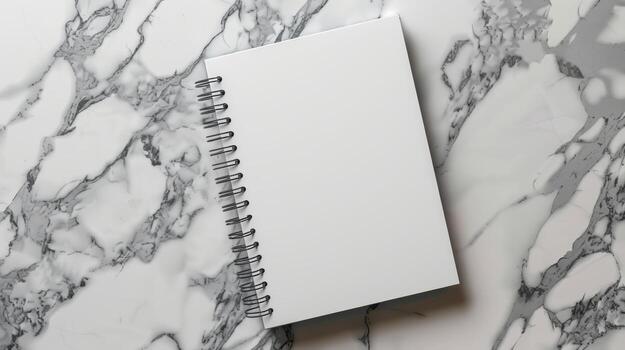 Blank Spiral Notebook on Elegant Marble Surface Background photo