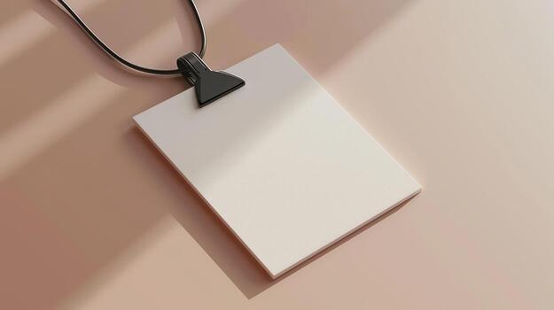 Blank Card Hanging on Black String with Soft Shadows on Surface photo