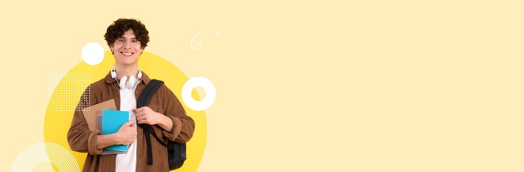 A happy student holds a stack of books and a backpack in a contemporary educational environment. Bright colors and design elements create an energetic and inviting atmosphere. photo