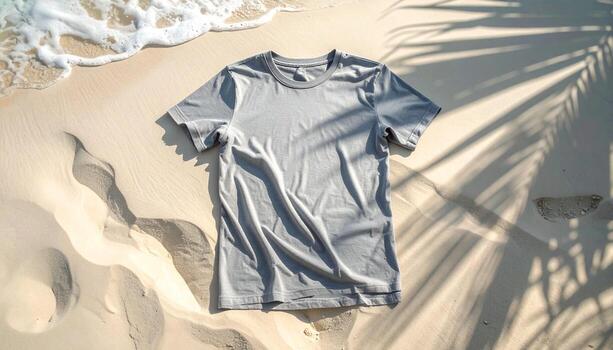 Gray TShirt on Sandy Beach with Palm Tree Shadows. photo