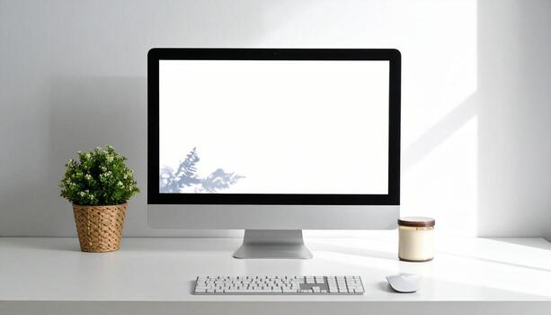 Minimalist Workspace with Computer, Plant, and Candle on White Desk. photo