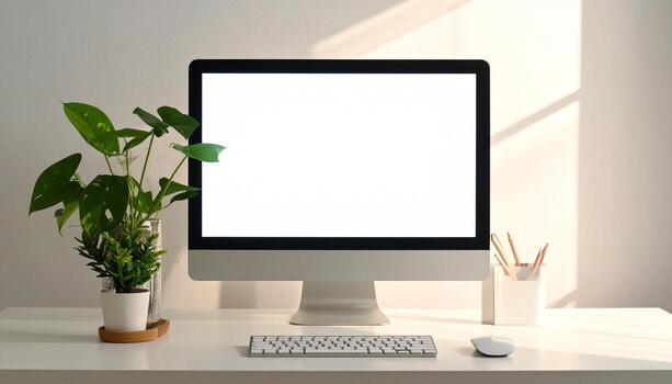 Minimalist workspace with computer plant and sunlight creating a serene atmosphere. photo