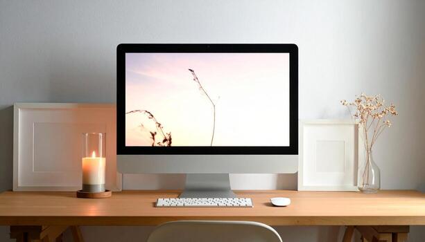Minimalist Workspace with iMac Candle and Floral Arrangement. photo