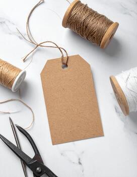 Craft Tag Mockup with Twine and Scissors on White Marble. photo