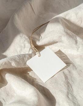 Elegant Square Tag on Soft White Fabric Background. photo