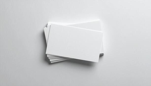 Stack of blank business cards resting on a white surface, ready for branding and customization, conveying a clean and professional aesthetic. photo