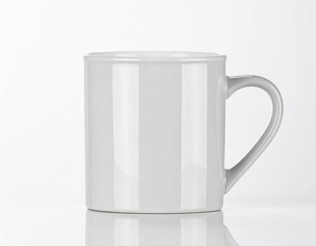 White ceramic mug sitting on reflective surface against a plain white backdrop, showcasing its simple form and minimalist aesthetic. photo