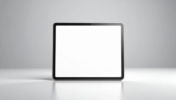 Modern tablet displays blank white screen on minimalist surface, ideal for showcasing app interfaces or digital content in a clean, professional style. photo