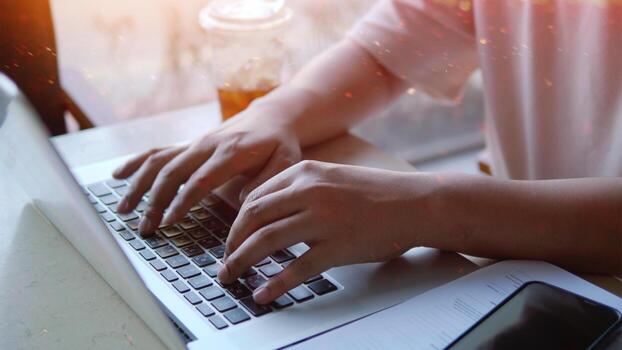 Writing documents on a laptop and communicating, sending emails and programming via computer systems photo