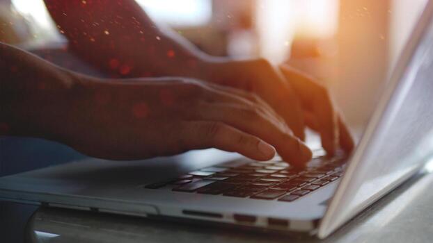 Writing documents on a laptop and communicating, sending emails and programming via computer systems. photo