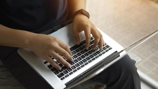 Writing documents on a laptop and communicating, sending emails and programming via computer photo