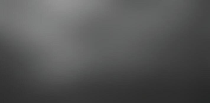 A blurred monochrome image showcasing a gradient of light and dark shades, creating a soft and abstract visual effect.black and gray gradient abstract background vector