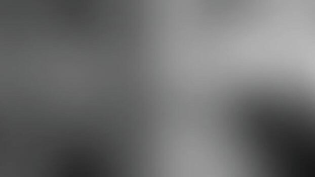 A blurred monochrome image showcasing a gradient of light and dark shades abstract background., creating a soft and abstract visual effect.black and gray gradient background vector