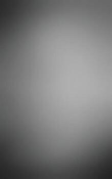 A blurred monochrome image showcasing a gradient of light and dark shades, creating a soft and abstract background visual effect.black and gray gradient background vector