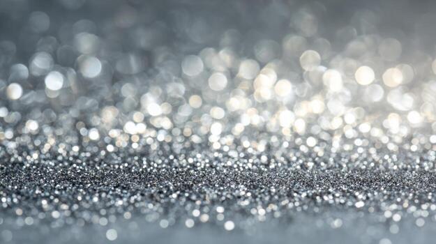 Shimmering silver glitter sparkles on a surface in bright light creating a magical atmosphere for celebrations photo