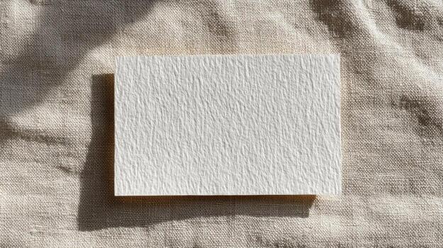 Textured White Paper On Natural Fabric Background. Minimalist Design And Eco-Friendly Materials photo