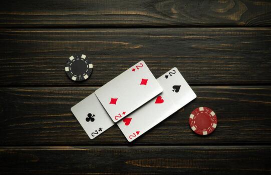 A successful and winning layout of a poker game on a vintage table in a club from a combination of four of a kind or quads and chips photo