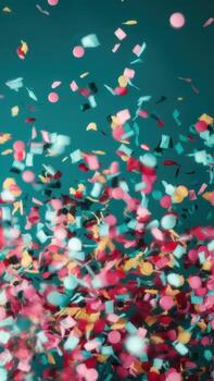 Colorful Confetti Falling Against a Solid Teal Background photo