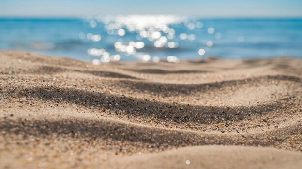 Close up Shot of Sand Patterns on a Sunny Beach Near the Ocean During Daytime photo