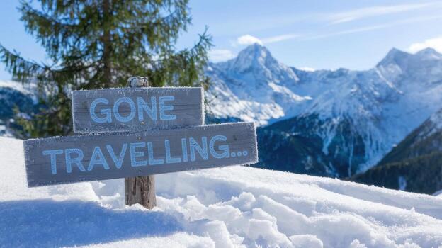 Gone Travelling Message on Sign in Snowy Mountains of Europe on a Bright Day photo