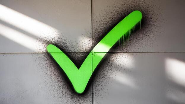 Green Check Mark Graffiti on a Gray Tiled Wall With Shadows photo