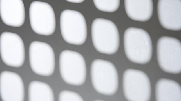 Shadows Cast by Window Form Grid Pattern on Light Gray Wall During Daytime photo