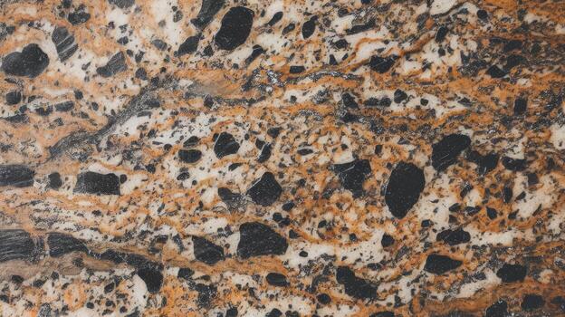 Close up View of Exotic Granite With Orange Veins and Black Inclusions photo