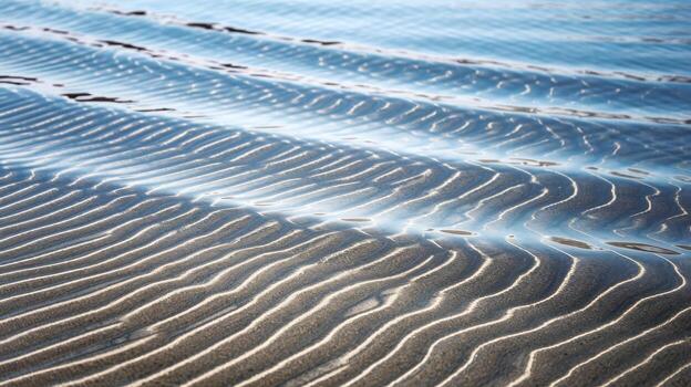Shallow Water and Sand Patterns Create Peaceful Scene on a Beach During a Sunny Day photo