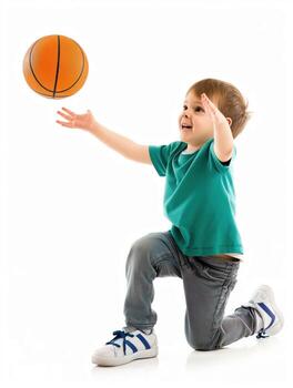 A young boy is playing with a basketball, reaching up to catch it photo