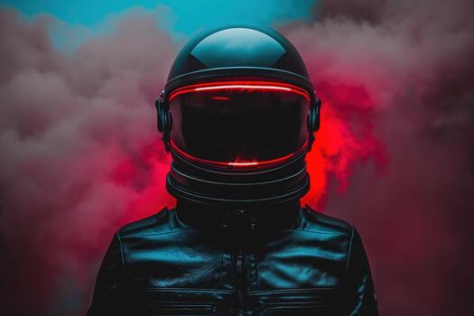 A man in a black helmet is standing in front of a red background photo