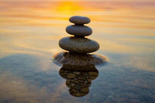 A stack of stones is sitting on top of water photo