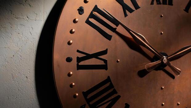 A large clock with roman numerals on the face photo