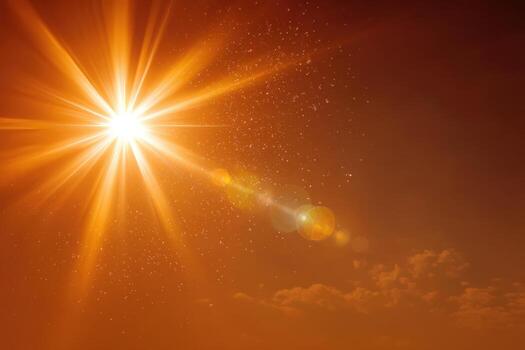 Bright sunburst radiating warm light through a vibrant orange sky, creating a stunning visual effect with soft clouds and sparkling particles in the atmosphere photo