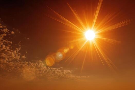 Bright sun radiating golden light against a backdrop of soft clouds in a vibrant orange sky, creating a warm and inviting atmosphere of a sunny day photo