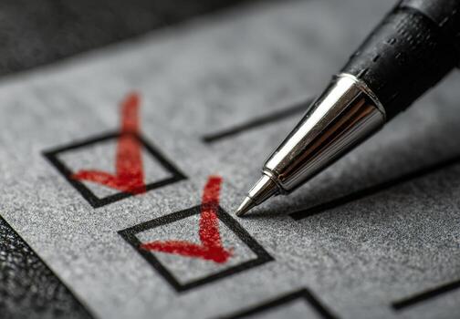 Close-up of a checklist with red check marks, a black pen poised above, symbolizing task completion, organization, and productivity in a professional setting photo